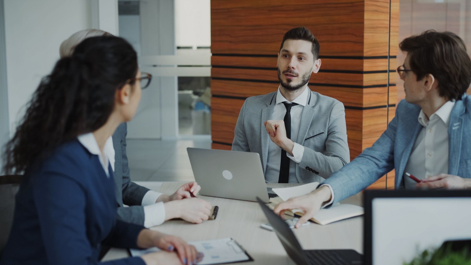 Luxivest advisory team reviewing client portfolios together in a meeting room